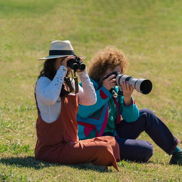 Carla Rhodes and Jen Bonner birdwatch with a long-lens camera at Omni Resort.