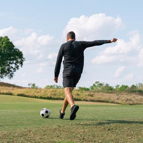 Luke Boden kicks a soccer ball on the footgolf course at Reunion Resort.