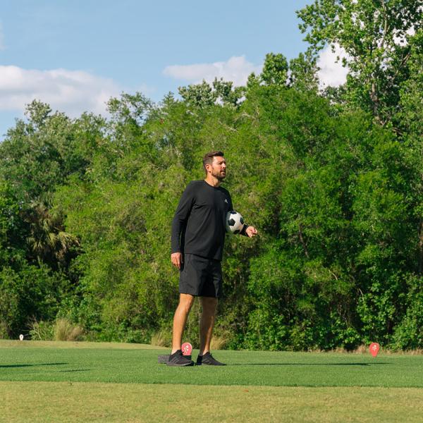 Luke Boden preps to kick a soccer ball at reunion footgolf course.