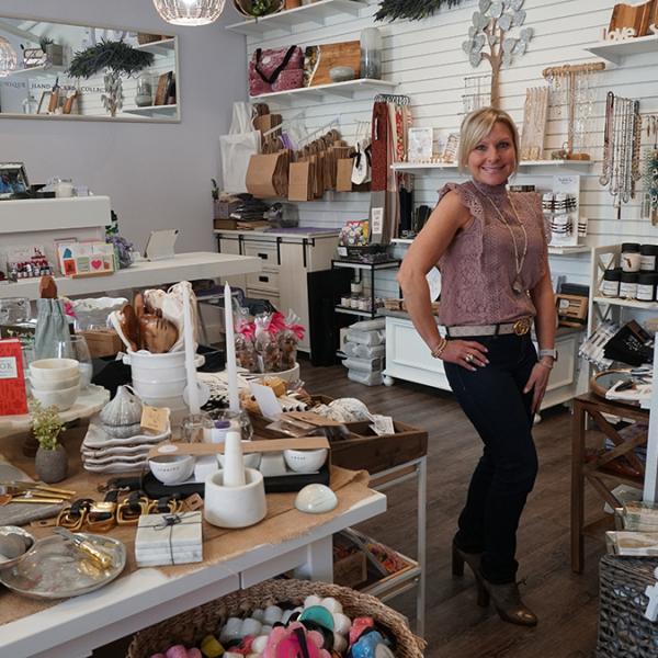 Woman posing in front of accessories in a boutique in Downtown St. Cloud.