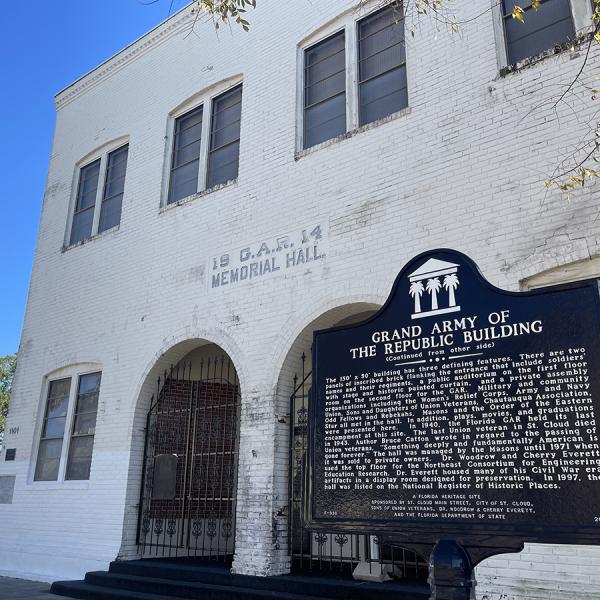White building with historic sign outside in St. Cloud.