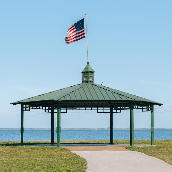 Pavilion with an American flag on top near the water in St. Cloud. 