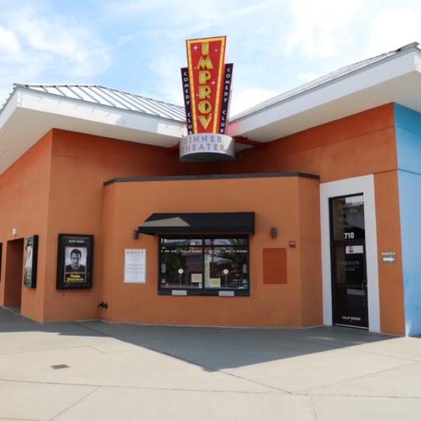 Exterior of the Funny Bone Comedy Club at The Pointe Orlando, featuring its marquee sign and main entrance on a sunny day.