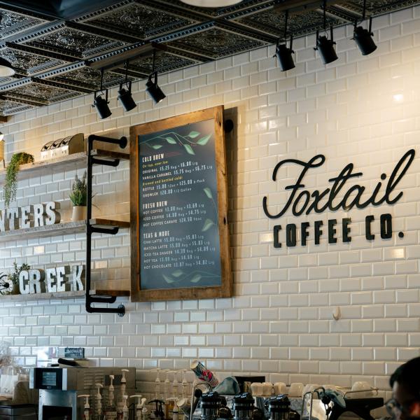 Interior of Foxtail Coffee Co. featuring a rustic, industrial design with modern lines, showcasing cozy seating, wooden accents, and stylish lighting.