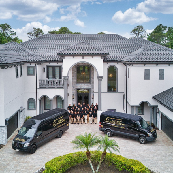 The exterior of The One by Magical Vacation Homes features a large horseshoe paved driveway, a large entryway, and a couple balconies.