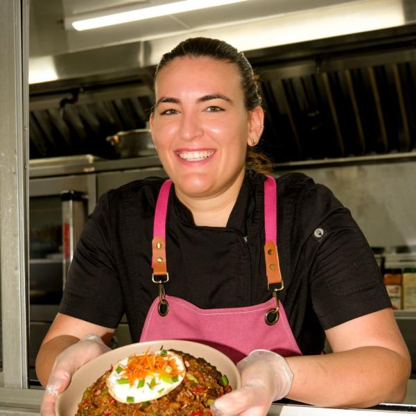 Chef Amanda Melendez holds a dish out of her food truck