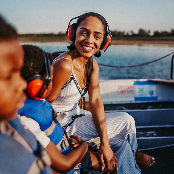 Woman and two boys sitting on airboat in Kissimmee.