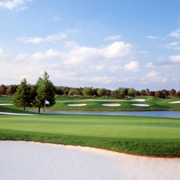 A tree-lined golf course on a sunny afternoon in Kissimmee, Florida.