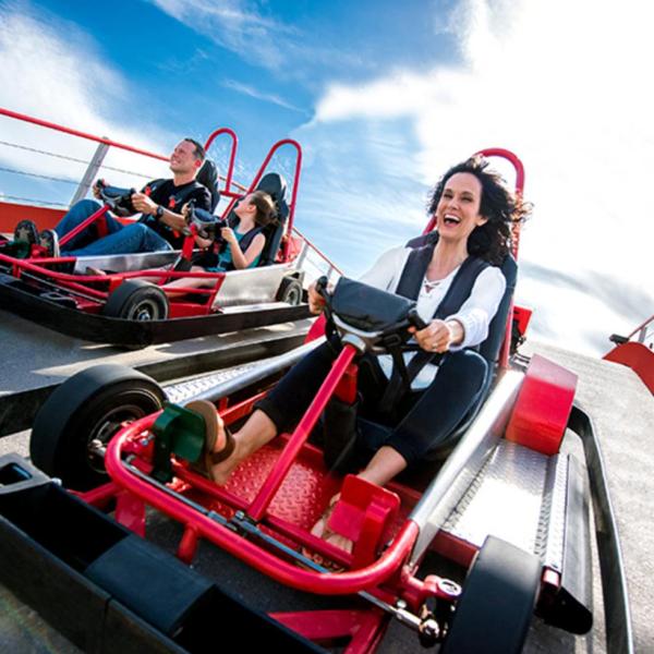 A woman rides a go-cart.