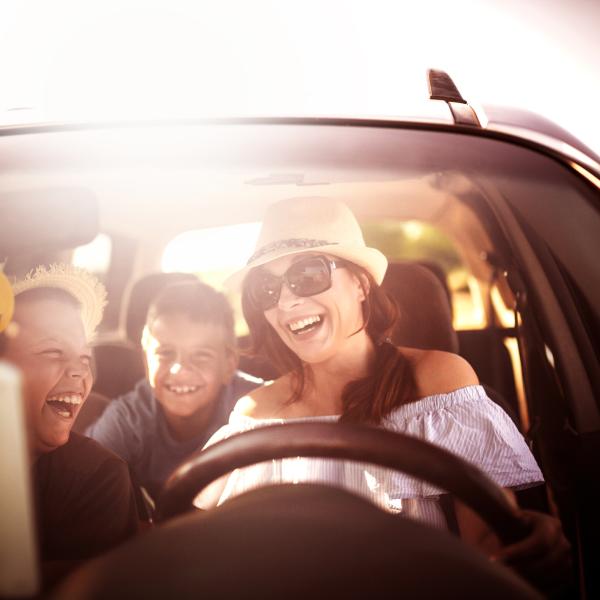 Family Driving In Car On Road Trip