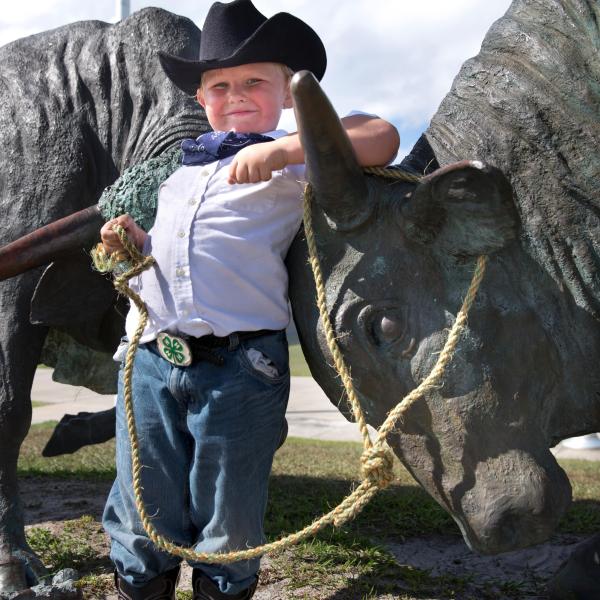 Young boy at Silver Spurs Rodeo in cowboy outfit.