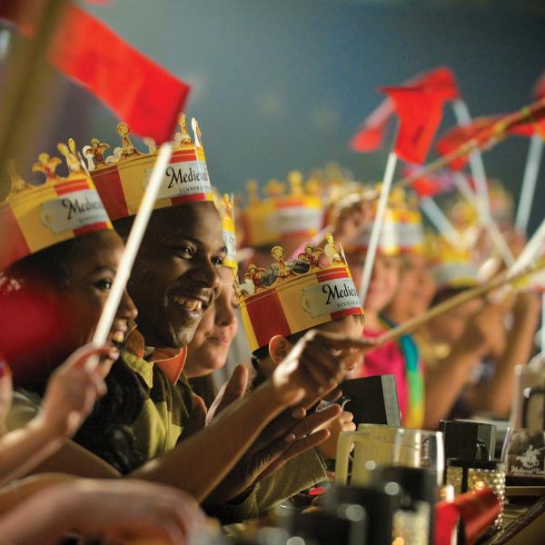 A family cheers during a Medieval Times performance 