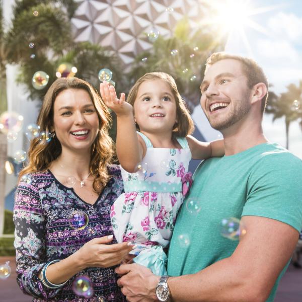 A family poses outside the Epcot Center 
