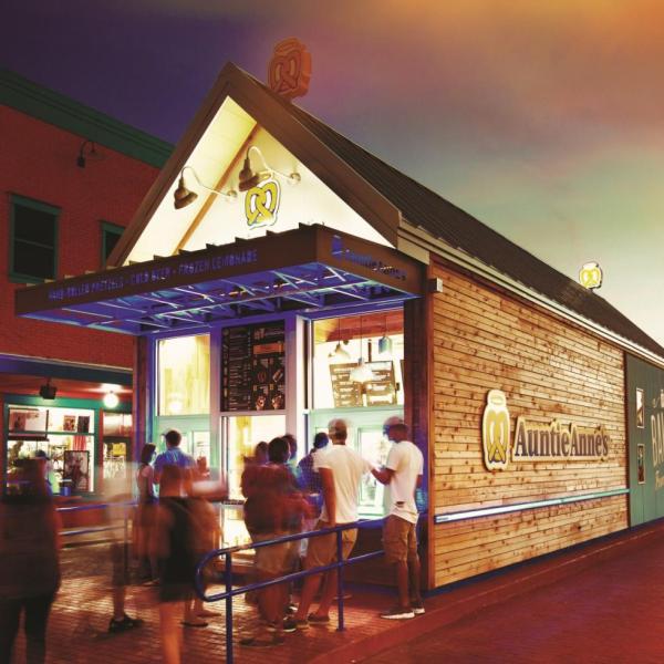 Patrons wait outside an Auntie Anne's for service. 