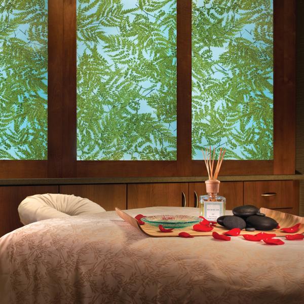 Peaceful spa treatment room with a massage table, rose petals, hot stones, and aromatherapy oils at Relâche Spa.