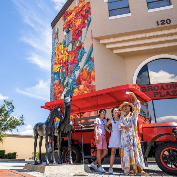 Three women take a selfie at Boardwalk Plaza in Kissimmee