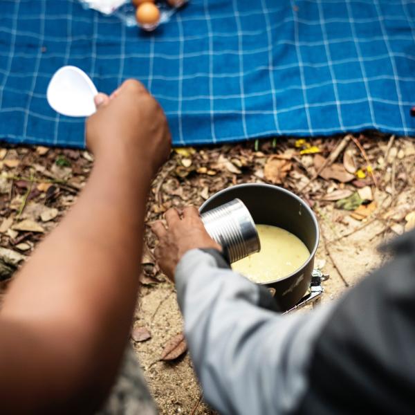 an overhead shot of folks sharing a meal at a campground