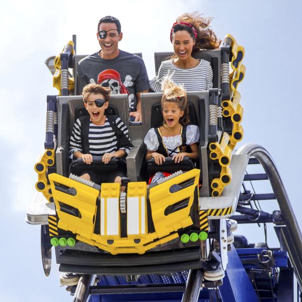 Vacationers ride a roller coaster at LEGOland in Kissimmee, Florida