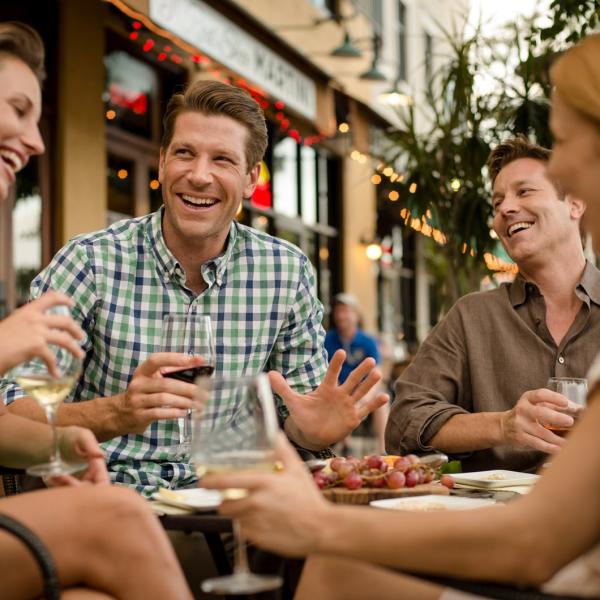 Men and women enjoying dinner and drinks at an outdoor cafe in Kissimmee