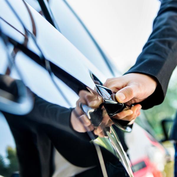 Chauffeur opening a car door